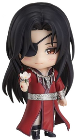 [Image ID: A figurine of Hua Cheng from the novel Heaven Official's Blessing. He is extending his right arm towards the viewer, holding a white flower in his hand. The figurine is a Nendoroid, produced by the Japanese brand Good Smile Company. End ID.]